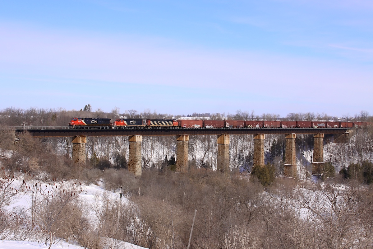 Three CN locomotives lead this westbound freight train across the single-tracked trestle in Georgetown.  This span has since been double-tracked and the piers have been widened to be able to support three tracks, part of the upgrades for future transit expansion.