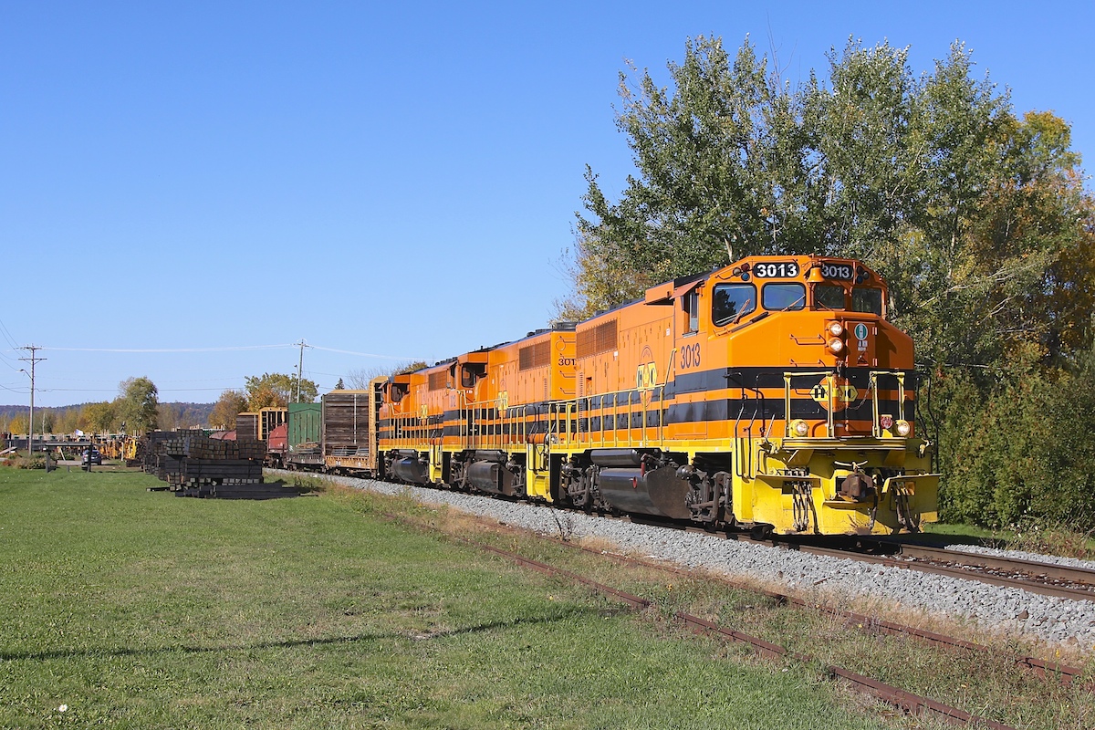 A trio of ex-CN geeps bring their train, consisting of manufactured product from Essar Steel Algoma, through Echo Bay on a beautiful autumn afternoon.