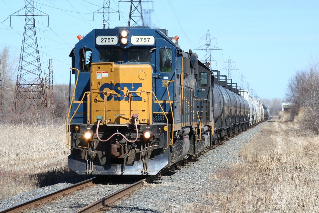 The daily CSX transfer led by the typical pair of GP38-2s heads south on CN industrial to return to home rails with interchange traffic lifted from the main CN yard at Sarnia.