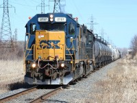 The daily CSX transfer led by the typical pair of GP38-2s heads south on CN industrial to return to home rails with interchange traffic lifted from the main CN yard at Sarnia.