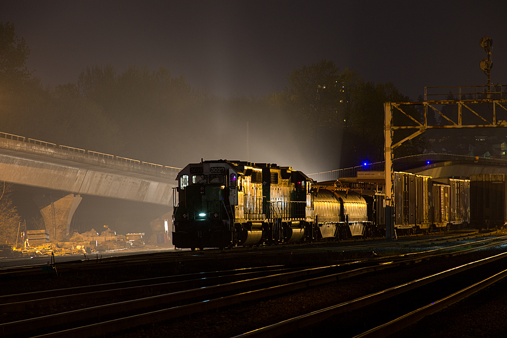 A night shoot out at the busy spot of Braid, finds some BNSF local power being silhouetted by the bright lights of another set of going on duty.