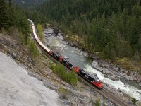 A trio of factory fresh ES44ACs do the bidding on the former BC Rail line, bringing southbound train 570 through the Pemberton Valley, passing the flowing river that feeds Nairn Falls. Not being able to operate in the US because they are Tier 3, 25 of these units are now based out of Prince George, doing freight duties on the BCR, as well as coal service. 