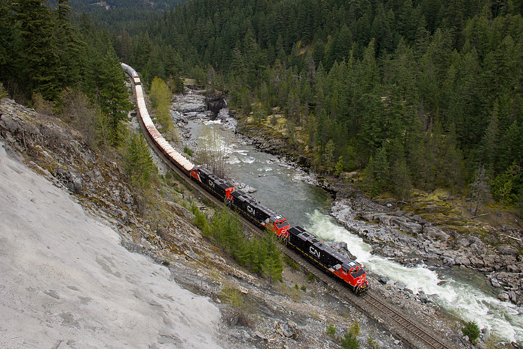 A trio of factory fresh ES44ACs do the bidding on the former BC Rail line, bringing southbound train 570 through the Pemberton Valley, passing the flowing river that feeds Nairn Falls. Not being able to operate in the US because they are Tier 3, 25 of these units are now based out of Prince George, doing freight duties on the BCR, as well as coal service.