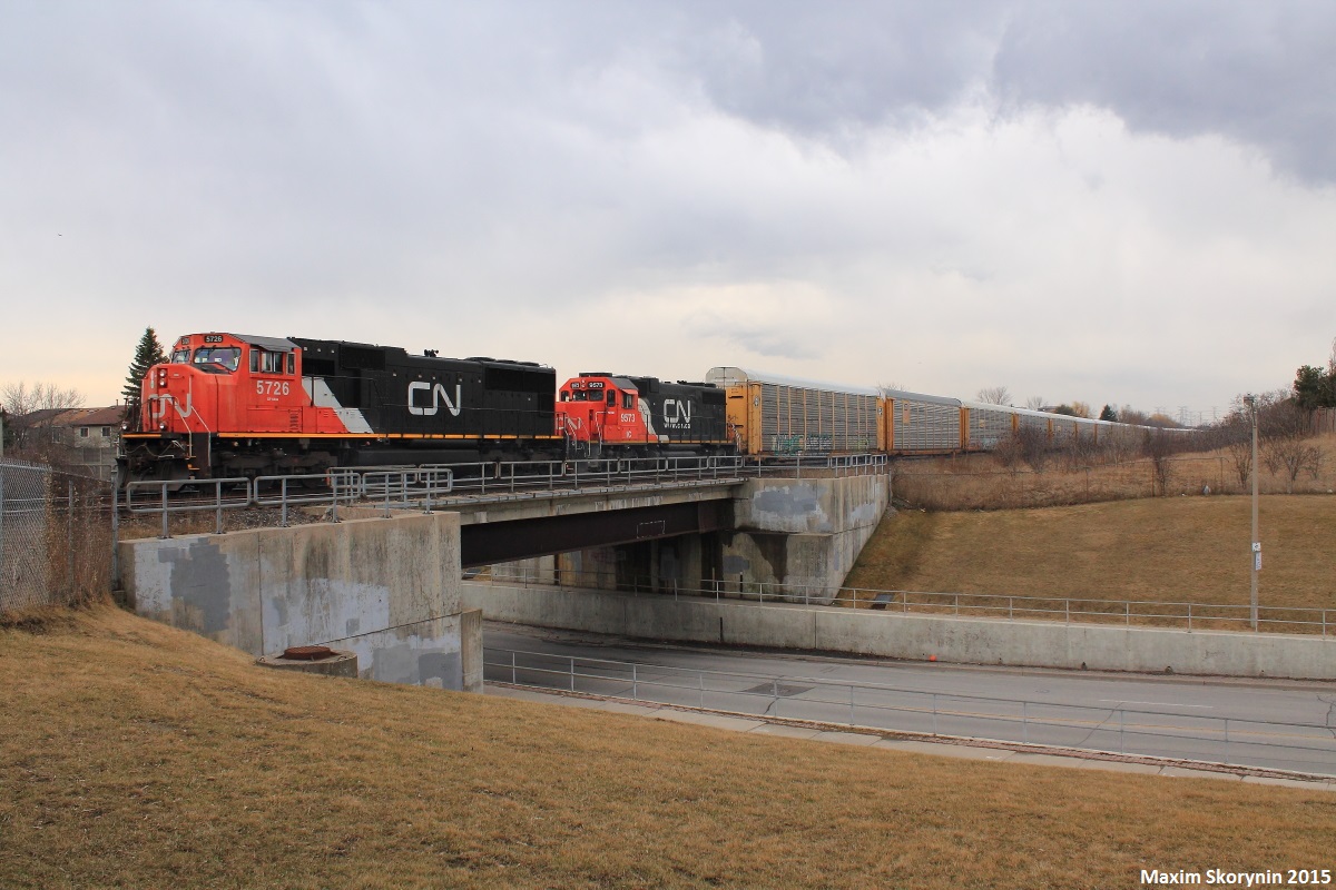 After spending a nice relaxing day track-side at various locations along CN's York Subdivision's, with the day coming to an end I was treated to a eastbound autorack train with CN 5726 leading Illinois Central 9573, which was online and working. 9573, was built in 1972, and is a EMD GP38-2 locomotive with 2000 horsepower to it, and its maximum speed being 65mp/h. With only 14 left, this was my first time seeing one of these and probably one of the last.