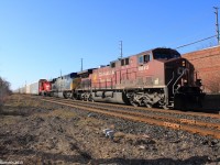 On April 12th of 2015, we traveled to Streetsville, Ontario to see Canadian Pacific train #244 with a CSX Transportation unit sandwiched between a CP General Electric AC400CW and a GMD GP20C-ECO locomotive. The shiny apple red GP20C-ECO, has been freshly rebuilt and re-painted from older SD40-2 models that are becoming rare to come across. Here, the train is pictured passing the Thomas Street railroad crossing on its way to CP's Toronto Yard