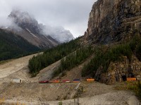 CP 8762 hauls up the Big Hill, passing underneath towering Mount Stephen, as the clouds band around in an attempt to hide Cathedral Mountain.