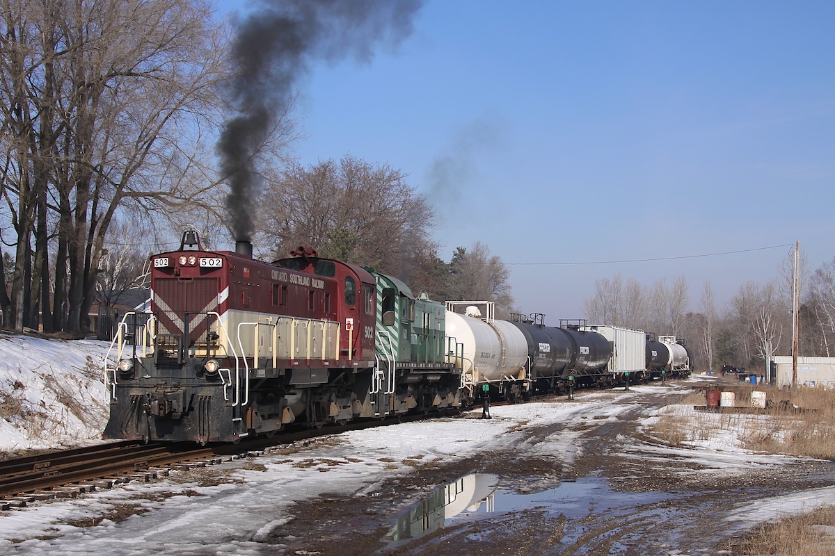 On a wet day in March, two S-13 locomotives shuffle cars around in the yard at Tillsonburg.