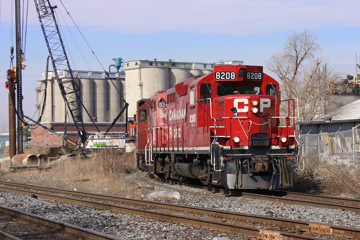 In the midst of piles being driven into the ground, CP 8208 leads a train of autoracks around the curve at mile 0 of the Mactier Sub. At this point in time, work was well underway on the grade separation project at the West Toronto diamond.