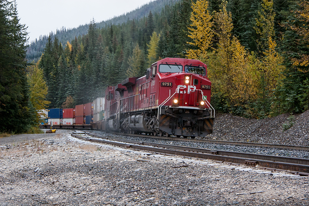 Looking in the other direction from the previous image, approximately a year before, we see CP 9751 grinding her way up the Big Hill at Yoho, sanders in full blast. Note the striped plow that this celebrity engine wore for the movie Unstoppable, with a near clean paint scheme.