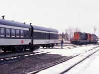 Trainman Gerald Turner prepares to couple Terra Transport baggage car 1308 and coach 764 to NF210's 927 and 935 just prior to the departure of Mixed Extra 935 West at Bishops Falls, Newfoundland on April 16, 1988. Formerly known as Train # 203, this mixed train with a passenger only consist would travel 138 miles to the city of Corner Brook by crossing the Gaff Topsails, the highest point of the railway on the entire Island at 1550 feet above sea level. The only passengers to travel the entire route that day were the photographer and his friend Paul, one other, a cabin owner who had gotten on Millertown Junction would depart at Gaff Topsail. This scene was on borrowed time as just a few months later on September 30, this train and all other rail service in Newfoundland would be shut down for good and the rails removed. Images such as these can be seen in my two books, RAILS ACROSS THE ROCK and it's sequel, RAILS AROUND THE ROCK, published by Creative Book Publishing of St. John's. 