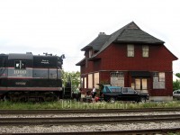 <I>The debut of the Credit Valley Explorer.</I> A keyboardist is setup beside the former CP bunkhouse/ restaurant at the old station site playing music for the limited crowd who will board the one coach train and travel down the former Owen Sound Sub to Snelgrove and return. The boarded up eye sore wouldn't be my first choice for a boarding location for a tour train through the Hills of Headwaters, however less than a year after this image was taken, on March 16, 2006 the old historic building burnt to the ground. In it's ashes a new station arose, similar in design (albeit a smaller version) to the station which sat on the site before being moved a couple blocks over. A decade after taking this image, the Credit Valley Explorer still plies the rails between Orangeville and Snelgrove showing patrons the beauty of a little oasis a little northwest of Toronto. The train has grown to 3 cars and the old "Pride of Orangeville" has been replaced with a rebuilt GP9RM.