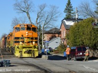 Ch-Ch-Ch-Ch-Changes. PNR track crews wave at GEXR 432 as they pass Kent/Dublin St in Guelph. PNR has been installing new crossing protection along Kent St, a new switch (just behind me) and CTC signals (also just behind me for the MP49 switch and siding).In this photo, the old protection stands guard warning Kent St. motorists of any nearby opposition on the railway - but this signal may be removed soon.  It should also be noted that Kent St runs on both sides of the railway - this is in effect fully separated street-running.All signalled crossings on the Guelph sub are effectively being replaced with CTC compatible equipment.