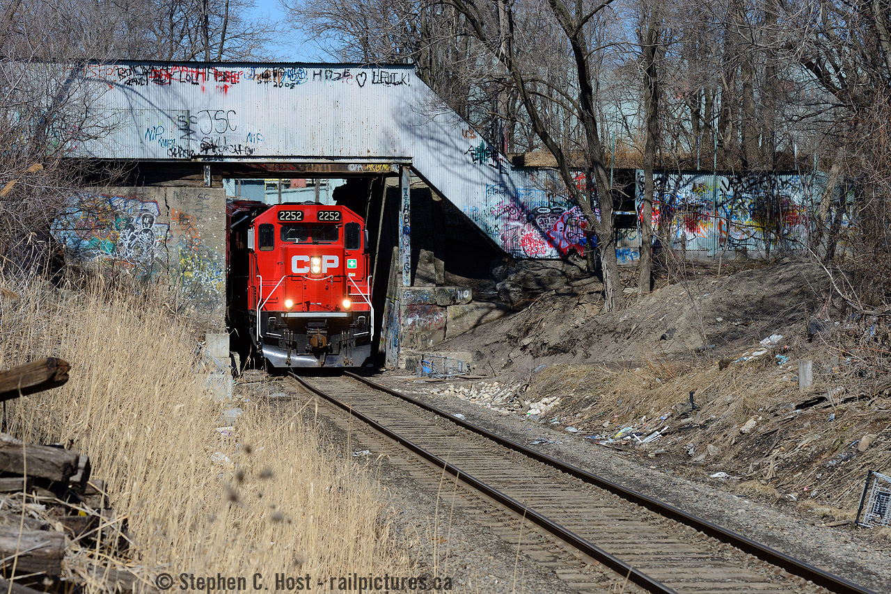 Welcome to the North End of Hamilton. TH31 is heading back to Kinnear on CP's Hamilton Belt Line (ex TH&B) and passing under the CN Grimsby Subdivision. Also seen is an abandoned Dofasco pedestrian overpass, once used to connect a parking lot out of sight at left, under the CN right of way to the sprawling Dofasco facilities on Beach Rd. The other end of the parking lot was also the location of the TH&B's 'Little Belt line' and the switch for the little belt was about 1/2 mile behind me near Barton St.Hamilton watchers would also be interested to know, the former Consumers Glass (a TH&B customer) has also been razed to the ground not far from here.Any TH&B fans with photos from these areas to share? I'd more than welcome seeing some from the north end of Hamilton in its glory days :)