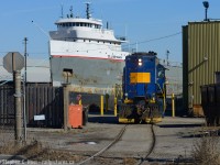 More north end Hamilton: Ships and trains - RLK 4003 has finished setting off some Cylindrical CWB-style hoppers on the Bunge Bayside lead, and  the Great Lakes Ojibway is moored along Pier 10 waiting for the seaway to open.