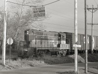 The engineer of TH&B GP7 73 watches as he shoves a cut of cars into the ADM Mill on the west side of the canal in Port Colborne.  I'm unsure of the date, likely around 1980.