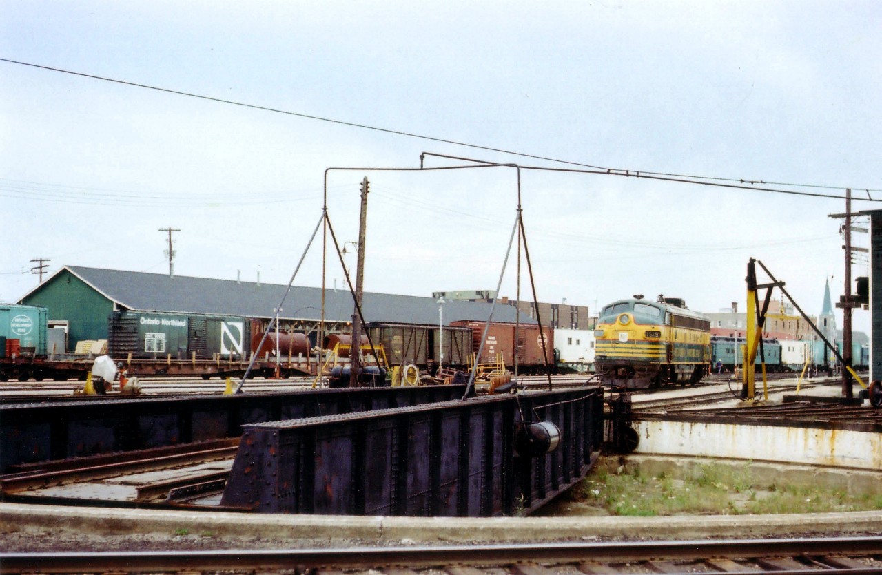 More of a historical image than artistic effort, this scene at the yard and turntable in Timmins is but a distant memory. In this image we see ONR 1519, as well as four paint varieties of 40 ft boxcars; one of which is wooden and probably served as a storage car back then. And the heavyweight coach could have been a Kitchen Car. I'd be interested if anyone could tell me what year the line into Timmins was torn up. Passenger service from Timmins to Porquis Jct ended at the startup of the Northlander in late 1977. The rail station still survives as a bus terminal.