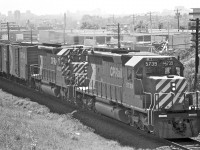 <br /><br /> It seems that Mr. James Adeney and I shared the same idea... capture some SD40's near the Victoria Park bridge in Scarborough.<br /><br /> Check out his awesome shot...<br /><br /><a href=http://www.railpictures.ca/?attachment_id=16861>http://www.railpictures.ca/?attachment_id=16861</a><br /><br /> James whooped me in the horsepower department, but at least I beat him to the scene (by a mere 22 years)! Notice the townhomes in his image? Back in '76, my photograph shows that only the cement block walls were standing. SD40-2, #5739 was barely a year old, while locomotive #5523 was celebrating a tenth birthday.<br /><br /> This shot was taken three years into my teens. I was still working to figure out all this aperture and shutter-speed stuff on my older brother's Pentax Spotmatic 1000. Wow... 39 years ago... seems like just yesterday... crazy!<br /><br />James... you have a wonderful portfolio here on RPca... thanks for sharing!