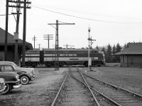 Wabash F7A 671 crosses the St. Thomas diamond with the London & Port Stanley Railway, heading eastbound on CN's Chatham-Cayuga Subs in 1967. A selection of vintage automobiles are parked next to the old Wabash/GTR station on the left, and semaphore signals guard the interlocking from movements on the L&PS.<br><br>This location, known on the timetables as St. Thomas, was the transition point from Mile 0.0 CN Chatham Sub to the west, to Mile 119.0 CN Cayuga Sub to the east, both formerly Grand Trunk lines (that the Wabash had running rights over) and originally built as the Great Western Railway's "Canada Air Line". The L&PS crossed this junction point north-sound at the diamond pictured. They were taken over in 1965 by CN and the line became the CN Talbot Sub and later Talbot Spur (the diamond here was Mile 15.0).<br><br><i><b>For more rail action in St. Thomas:</i></b><br>A L&PS passenger excursion at their station: <a href=http://www.railpictures.ca/?attachment_id=13531><b>http://www.railpictures.ca/?attachment_id=13531</b></a><br>L&PS passenger train hauling freight:<a href=http://www.railpictures.ca/?attachment_id=13490><b>http://www.railpictures.ca/?attachment_id=13490</b></a><br>A C&O train coming off the connector onto the CASO: <a href=http://www.railpictures.ca/?attachment_id=14920><b>http://www.railpictures.ca/?attachment_id=14920</b></a><br>An NYC (PC) rail instection car pays a visit: <a href=http://www.railpictures.ca/?attachment_id=14921><b>http://www.railpictures.ca/?attachment_id=14921</b></a><br>Chessie-painted C&O Geeps retired & stored: <a href=http://www.railpictures.ca/?attachment_id=14938><b>http://www.railpictures.ca/?attachment_id=14938</b></a>