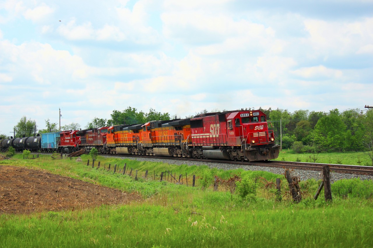 SOO 6053 (SD 60) leads BNSF 5321, BNSF 4549, CP 9821 and CP 3120 out of Puslinch,  rounding the bend just before MM44 crossing  Victoria Road with a load of MT tanker cars.
