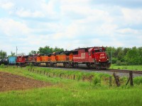 SOO 6053 (SD 60) leads BNSF 5321, BNSF 4549, CP 9821 and CP 3120 out of Puslinch,  rounding the bend just before MM44 crossing  Victoria Road with a load of MT tanker cars. 