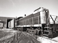 Port Colborne Harbour Railway 308, an Alco S-1, shoves a boxcar into the loading dock of the Interlake Paper plant in Thorold.  This was the last industry left on the Town Line Spur, rail service ended in 2007 after a bridge was damaged by arson.