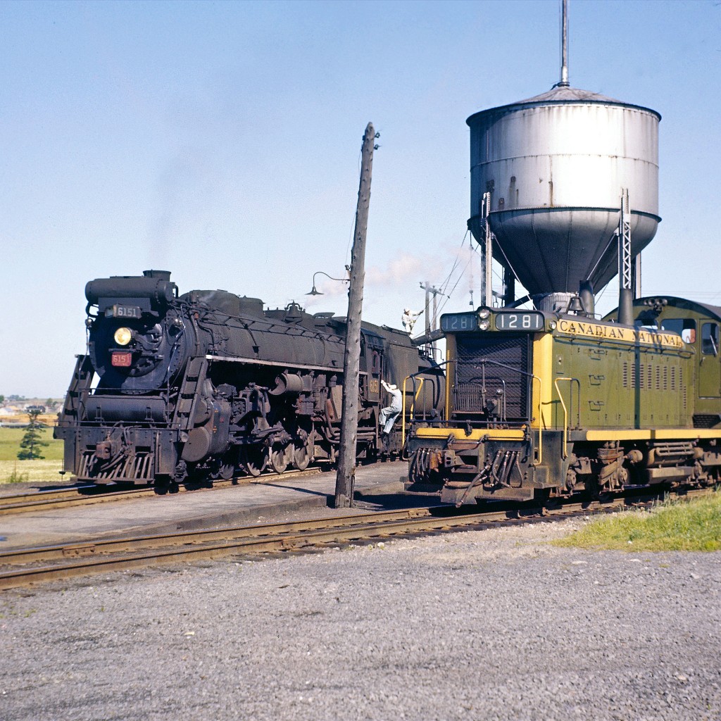 This is one of my favorite Del Rosamond images.  I’m guessing it was taken around 1959.  Unfortunately, he rarely made any notes on the edges of his large format slides (2.75” squared).  Del didn’t live far from where this picture was taken.  I wonder if he heard the distinctive Northern whistle and decided to go over and check out the action.  


I admire the way that Del purposely included the railway crew in his images.  In this shot we can see the engineer and fireman preparing for departure.   As I reflect on my own photography back in the 70’s, I tried pretty hard to make sure that no people “ruined” my shots.  I realize now how short sighted that was.   In many cases, it is the human factor that makes a photograph interesting.  Just my two cents worth.


My RPca e-mail pal, Dave Tinslay, tells me that he’s building a time machine.  When he gets the bugs worked out, I’m hoping he’ll let me borrow the keys.  I’d love to zoom back and go rail-fanning with Del.  I’ve learned that he was a real gentleman.   It would be awesome to see some of these Northern-types in action and to witness the final days of Canadian steam.  


If Dave filled the tank and loaned you the keys, where would you go? 


Peter Newman