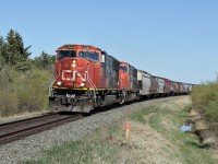 A pair of SD75I's, CN 5680 and CN 5714 head a grain train west away from Ardrossan.