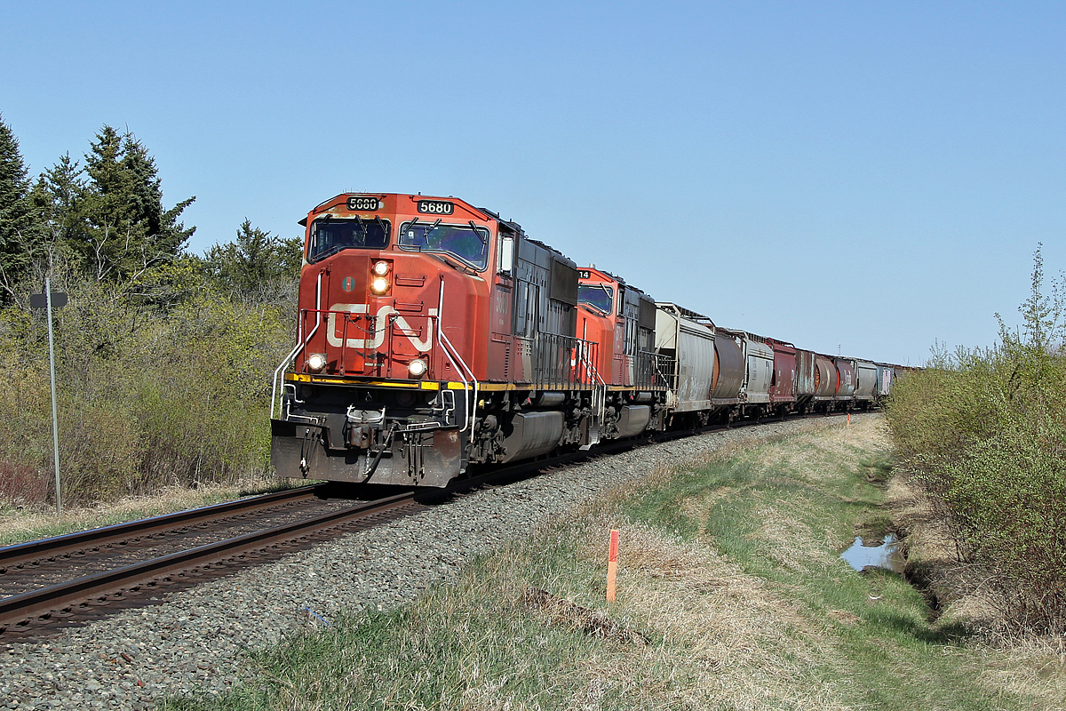 A pair of SD75I's, CN 5680 and CN 5714 head a grain train west away from Ardrossan.