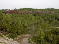 A loaded ballast train rolls through Cherrywood with a pair of veterans for power.