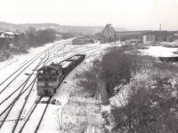 Cold day, few flurries in the air as I got out of the car on the Chatham St bridge to get a shot of the TH&B facilities as I knew the era of the beloved TH&B would be coming to a close. After all, the CP was taking over and that means old road was going to fall by the wayside. I was disappointed nothing was doing, save for #56 moving a couple gons around. The roundhouse (behind the fuel tank) and the old coaling tower would live but 5 more years and the yard would be cleared out. For many of us, this is a very nostalgic scene. James Adeney and Peter Newman are notably two members of this RP.ca group that spent time wandering and recording various scenes here back in the day. RIP, Chatham St. (Two tracks on the left are for the Aberdeen Yard, out of sight by a half mile,er..a Kilometer,  which still sees limited use.)