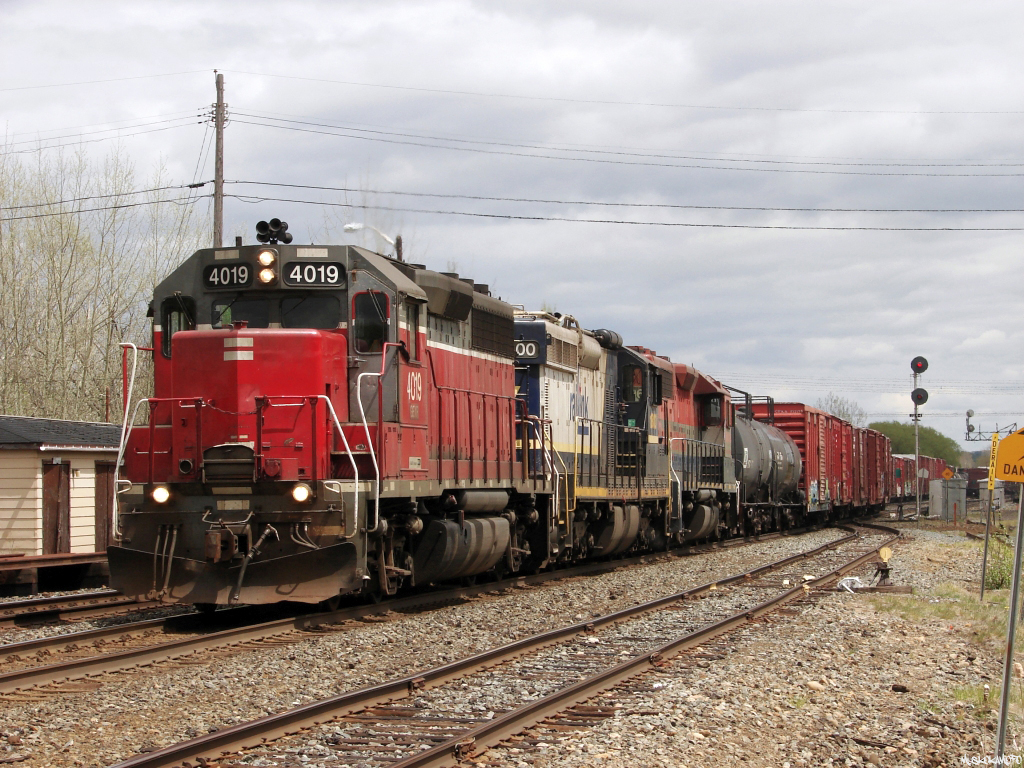 GEXR 4019 West crosses over to the South track with OVR 431 at Romford to do some work on the service track before heading into Sudbury to interchange with CP. 

A quick run down of this eclectic lashup: GEXR 4019 (GP40) was built in 1966 as Norfolk Western 1348 and was scrapped stateside sometime during the last couple of years after donating her power plant to rebuild an ONT 2201 (still being rebuilt...). RLK 1800 (SD18M) was built in 1959 as Southern Railway SD24 #6312, spending the 80's and 90's as Chicago North Western #6629 before being purchased by Railink sometime around 2000, meeting the scrappers torch in mid 2013. RLK 4096 was actually built as CN GP40 #4006 in 1966, and continues to work on the OVR today still running around in RailAmerica Red white and blue, looking exactly the same as it did here 5 years ago!