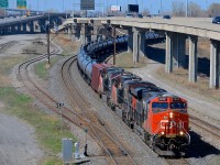 CN 704 (crude oil from Alberta for the Valero refinery in St-Romuald, Qc) has a trio of ES44DC's (CN 2333/2273/2236) as it slowly departs Turcot West after a crew change. They had to wait longer than usual to start pulling as CN 529, CN 324 & VIA 63 all were passing before the RTC could give 704 protection for the pullby.