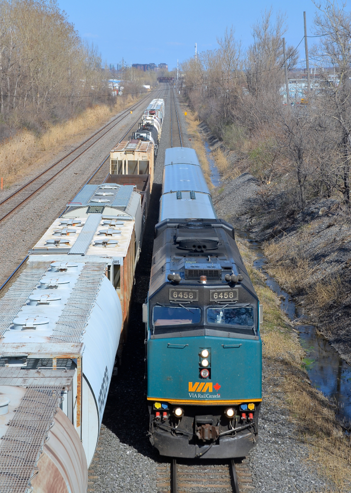 Two westbounds. At left is the rear of CN X321 and at right is VIA 59 with VIA 6458. Both are westbound through Lachine on CN's Montreal sub.