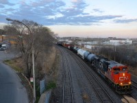 CN 309 is leaving Turcot West close to sunset with CN 8820 at the head end. Working as DPU is IC 1001.