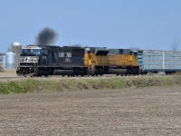 <b>An ex-Conrail SD60M smoking it up.</b> CN 528 is only a couple of miles from the U.S. border as it approaches Rouses Point, NY where it will become CP 930 and a CP crew will take over for the its journey south. The ex-Conrail leader (NS 6776) is smoking it up as the train accelerates. Trailing is ex-UP SD90 NS 7301