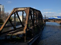 AMT 1356 pushes a deadhead movement over the Lachine Canal during the evening rush hour, passing the out of use swing bridge.