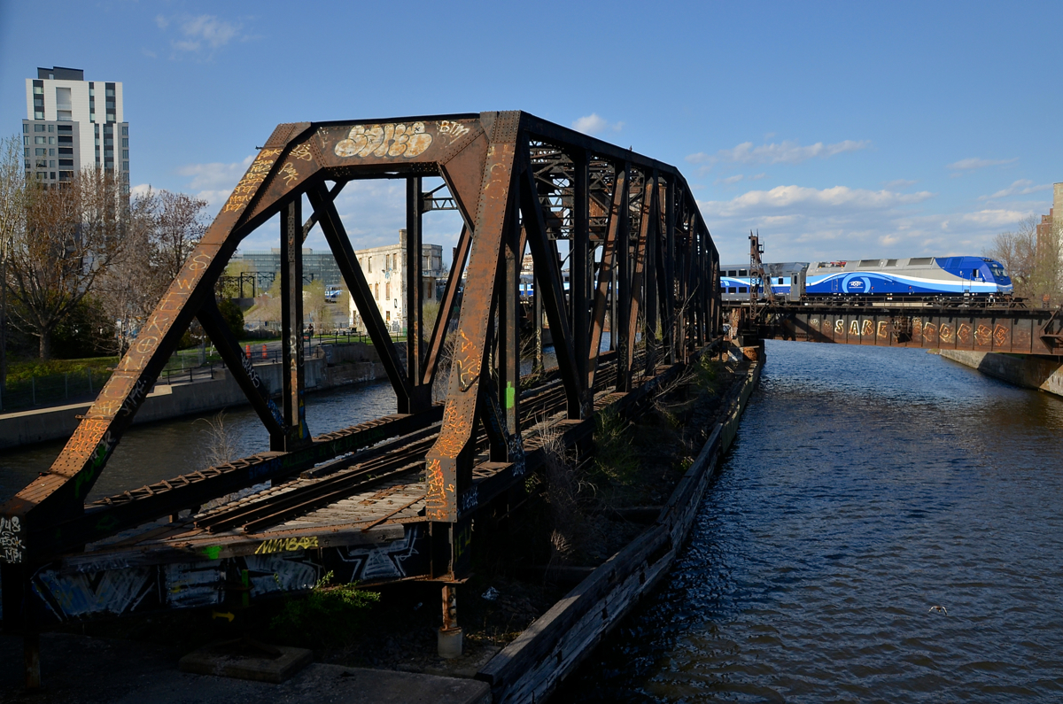 AMT 1356 pushes a deadhead movement over the Lachine Canal during the evening rush hour, passing the out of use swing bridge.