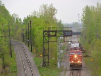 CP 9733 and an unknown ES44AC lead a pitifully short CP 253 through Montreal West on an overcast and muggy morning, its trip from Binghamton, NY almost complete. At left is North Junction which AMT commuter trains from the north shore use to get to downtown Montreal.