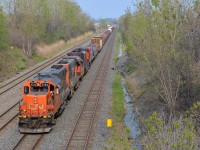 A pair of GP38-2's and an SD70M-2 (CN 4720, CN 4729 & CN 8815) lead CN 527 towards nearby Taschereau Yard. At the head end are quite a large cut of coil steel cars.
