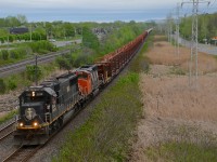IC 1010 & CN 5348 lead CN 482 which has empty rail cars, a loaded centrebeam and then 34 TankTrain loads for Maitland, ON.