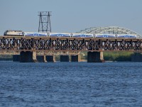 <b>Last train of the day for Candiac.</b> AMT 1342 has 5 Bombardier cars in tow as it heads towards Montreal's South shore with AMT 95, the last train of the day for Candiac. It is crossing over the St-Lawrence river on CP's double track St-Lawrence bridge. Behind it is the Mercier bridge.