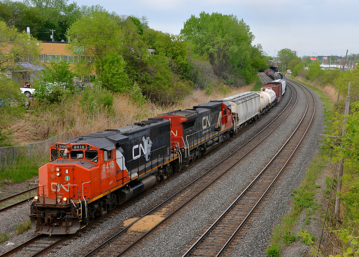 CN 323 has CN 9418 leading on its return to Montreal from St. Albans, Vermont , with CN 2037 trailing. It's become quite rare to see a GP40-2LW leader on a mainline freight so this was a nice treat, with 9418 in the short-lived North American paint scheme.