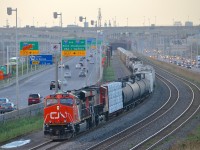 A shorter than usual CN 309 heads west with CN 2271 & CN 2331. In the background at left is a cut of grain cars and a GO Transit coach. CN 2271 is still shiny after being used on a CN business train.