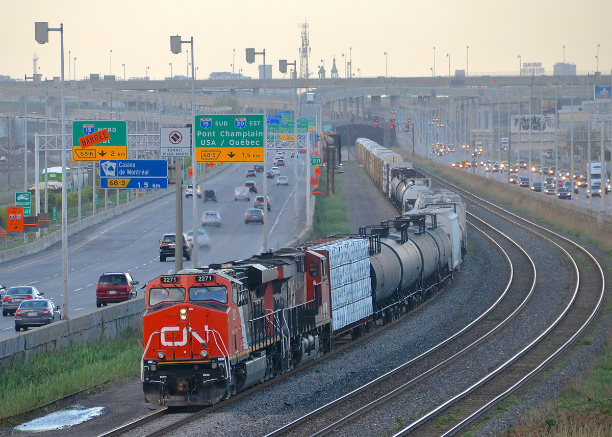A shorter than usual CN 309 heads west with CN 2271 & CN 2331. In the background at left is a cut of grain cars and a GO Transit coach. CN 2271 is still shiny after being used on a CN business train.