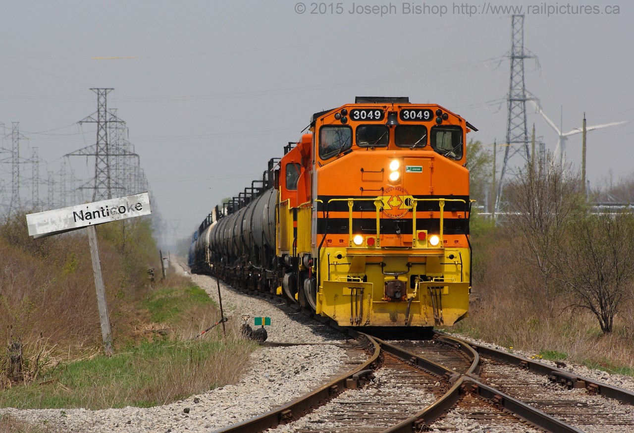 RLHH 3049 is seen leading SOR 595 by the Nanticoke Station sign.  It was a nice treat to get 3049 leading on the Hagersville Subdivision, with RLHH 3404 sidelined with a traction motor failure 3049 has been leading more frequently.    I have shot this angle a couple times in the past years and have seen many changes, mostly in the form of the motive power.  The Nanticoke sign is the thing that has not changed…does anyone have old Nanticoke photos of this angle?  They could make for a possible Time Machine contender on the Railpictures.ca Website.  If you have one, please feel free to share, I know the viewers would love to see it!