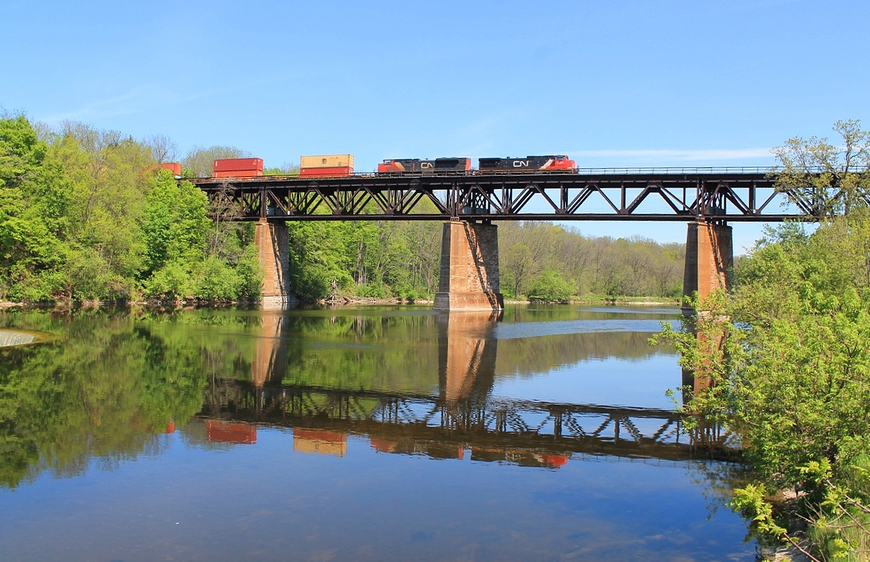 The eastbound all intermodal train #148 crosses the Grand River headed by 2524 and 8020.