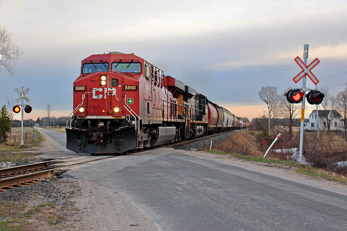 It's been over a year since I took this photo, and didn't think I could make anything of it. I gave it a shot though and found some decent colour actually came out of it. While I had lived next to the CP MacTier Sub for over half a year, this was the second time I had the mobility to head down to the CP tracks with my camera. The first time was unsuccessful, however this time the moment I got to the tracks with my bicycle, a headlight was rounding the corner over the Nottawasaga bridge, just two miles south. I was quickly aware this was CP 119, due to the hoppers up front, and containers behind. For power is CP 8860 and CSX 865 as it crosses 6th Line in Utopia, with no DPU's as usual. I'm glad I took advantage of this opportunity when I did, as CP, like most railroads were very power short at the time. If foreign power didn't show up, you'd have a good chance of being greeted with older EMD power. Besides Union Pacific power, foreign power is once again quite rare on the MacTier Sub. Even with UP power, 420 and 421 are usually the only trains that have them. For the most part though, CP GE's have full control of the MacTier now.