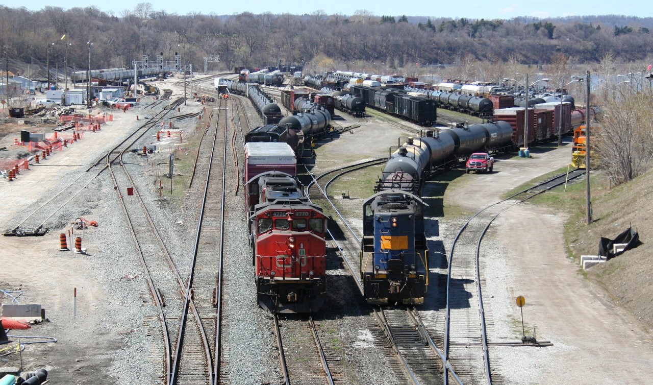 While RLK/SOR 4003 switches cars to the right, CN 4770 shoves its train of transfer cars from Aldershot yard into an arrival track at SOR's former CN Stuart Street yard in Hamilton.

The construction activity to the left is for new dedicated passenger tracks for expanded service on the line to Niagara Falls. Behind the photographer is a brand new construction for an extensive new passenger facility, ironically immediately adjacent to the location of the old CN Hamilton station.