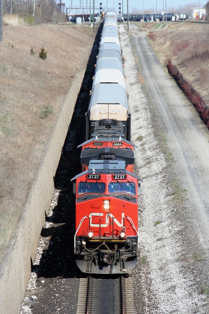 With a whistled greeting, CN 393 glides down the hill to the Paul M. Tellier railway tunnel (better known by its old name, the St. Clair Tunnel) with 115 cars in tow.