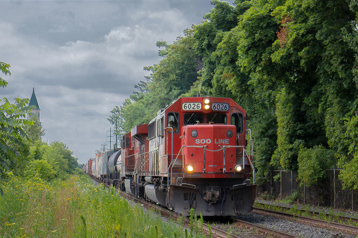 I grew up in Summerhill. Without a doubt, the SOO SD60's that rolled by my house when I was younger was the biggest motivation to get trackside, whether it be a hockey stick or candy apple. Like many things, I took them for granted. Never a big CP photographer until more recently, most of the SOO SD60's were rebuilt by the time I decided to take some of my attention away from CN. I had received word that CP 240 would have a SOO SD60 leader this day, and I made a specific trip to Toronto just for it. I staked out and waited at my favourite childhood railfanning location, at the east end of Summerhill. With 6033 at the helm, and properly placed 8790 in behind, 240 creeps up to the Balfour bridge at a steady 20mph. This would be the second time I'd get a picture of a SOO SD60, and on both occasions the sun would dip behind the clouds just seconds before the train got close enough into the viewfinder. I was quite angered, and left back for St. Catharines feeling empty handed. It's been almost a year, but I decided to try and edit the photo to see what would come of it. Not great, but better than my first attempt at it. Now especially, this shot means a lot to me as some of the unrebuilt SOO SD60's in service just last year are in storage, now that CP is no longer heavily short of power. I have had no luck since catching a pure SOO unit. As for the visual memories of SOO's passing by my house though, I will never forget.
